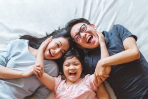 Bird’s eye view of man, woman, and little girl smiling together